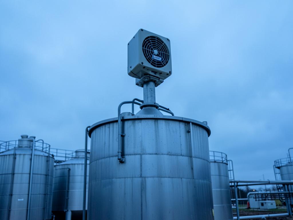Level transmitter mounted on top of a large industrial storage tank